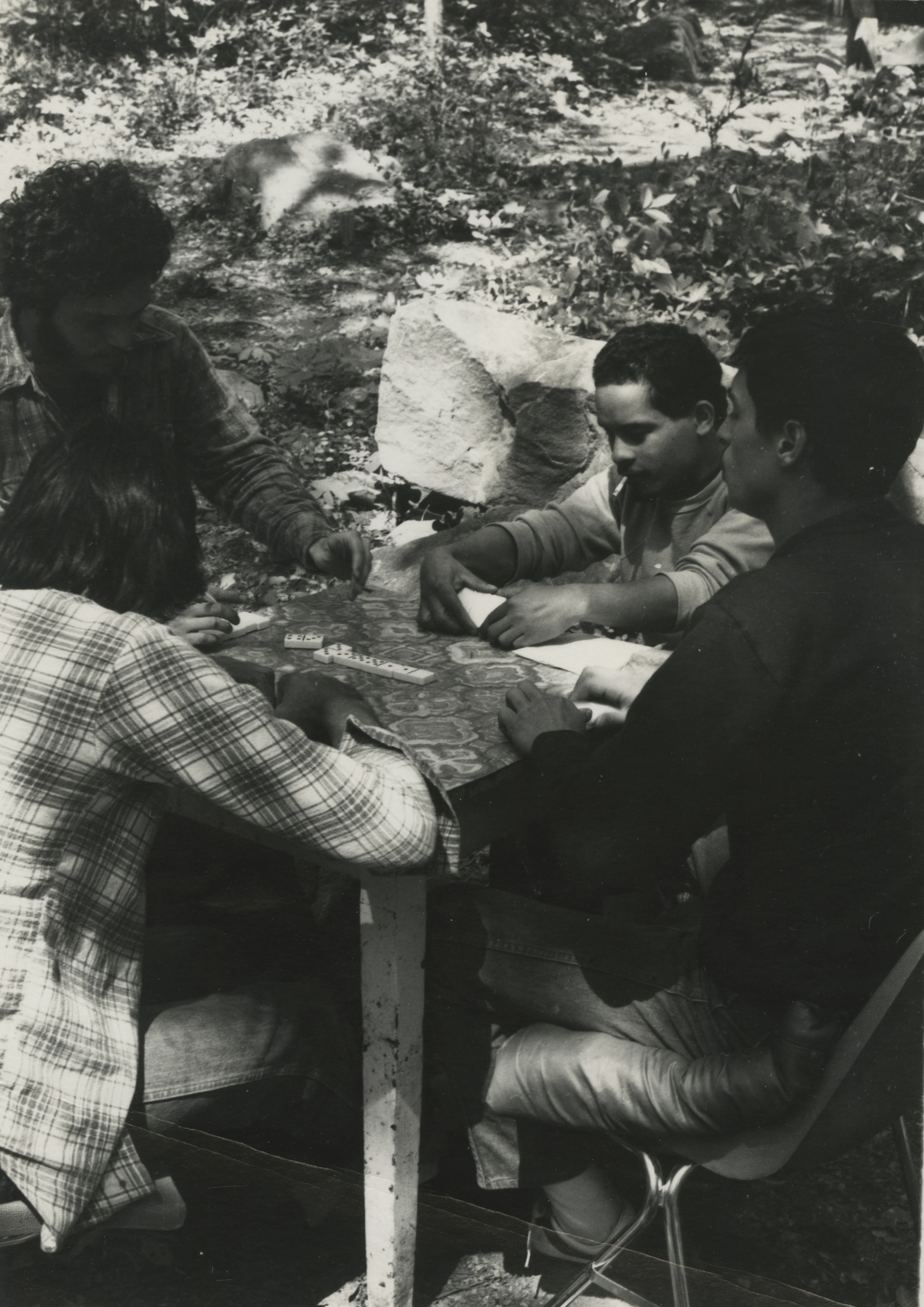 Friends gather to play Dominoes